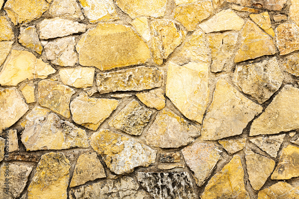 Fototapeta premium Background of dark yellow orange rough stone wall texture horizontal photo