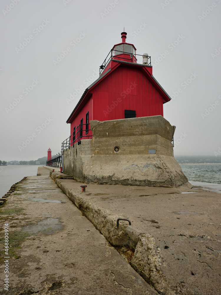 Grand Haven lighthouse on Lake Michigan as seen from the tip of the breakwater looking back towards the shoreline