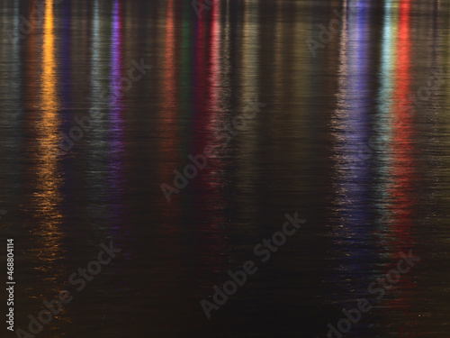 Stunning night view of calm water in front of Vancouver downtown with colorful city lights reflected on the water surface in British Columbia  Canada.