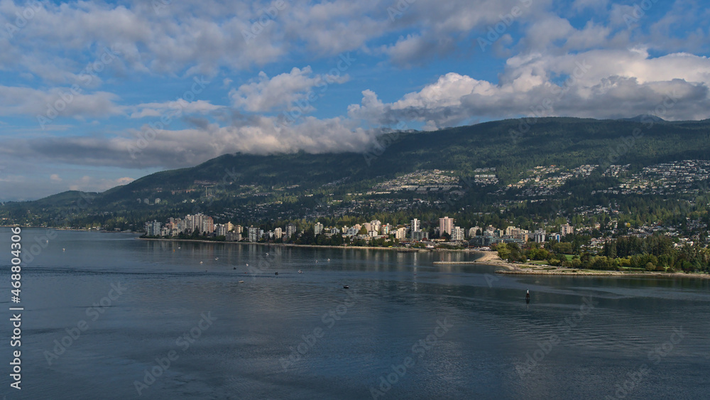Beautiful view of town West Vancouver, British Columbia, Canada on the shore of Burrard Inlet with Ambleside Park and residential high-rise buildings.