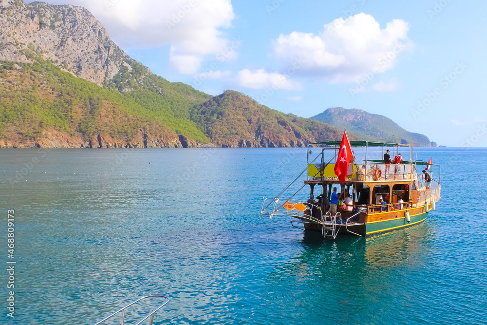 People having fun at yacht on the shore of the cozy bay of Adrasan, near Antalya and Kemer, Turkey
