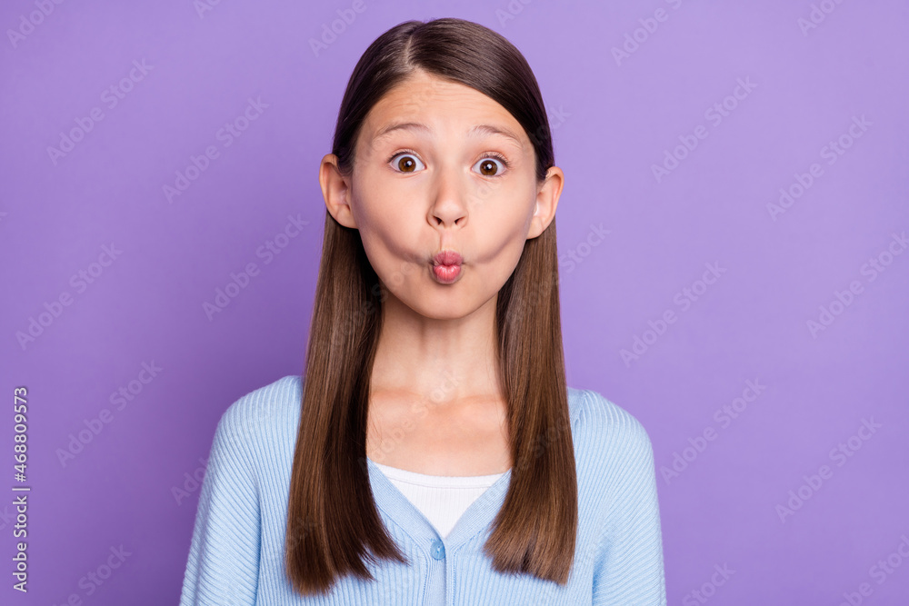 Photo of funny brunette little girl do grimace wear blue shirt isolated on violet color background Photo of funny brunette little girl do grimace wear blue shirt isolated on violet color background