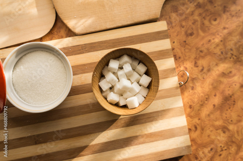 Sugar and refined sugar are poured into the sugar bowl on the table.