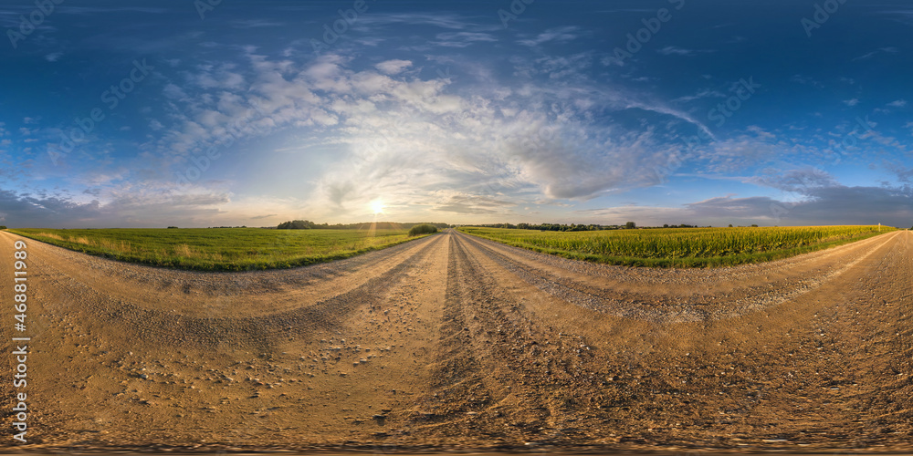 spherical hdri 360 panorama on gravel road among fields in summer evening sunset with awesome clouds in seamless equirectangular projection, ready for VR AR virtual reality