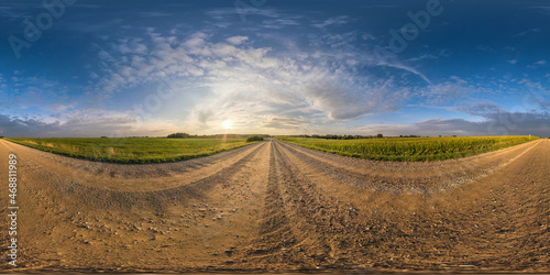 spherical hdri 360 panorama on gravel road among fields in summer evening sunset with awesome clouds in seamless equirectangular projection, ready for VR AR virtual reality