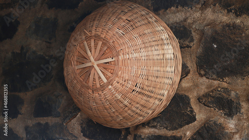 The basket made of hand-knitted bamboo is hung on the wall