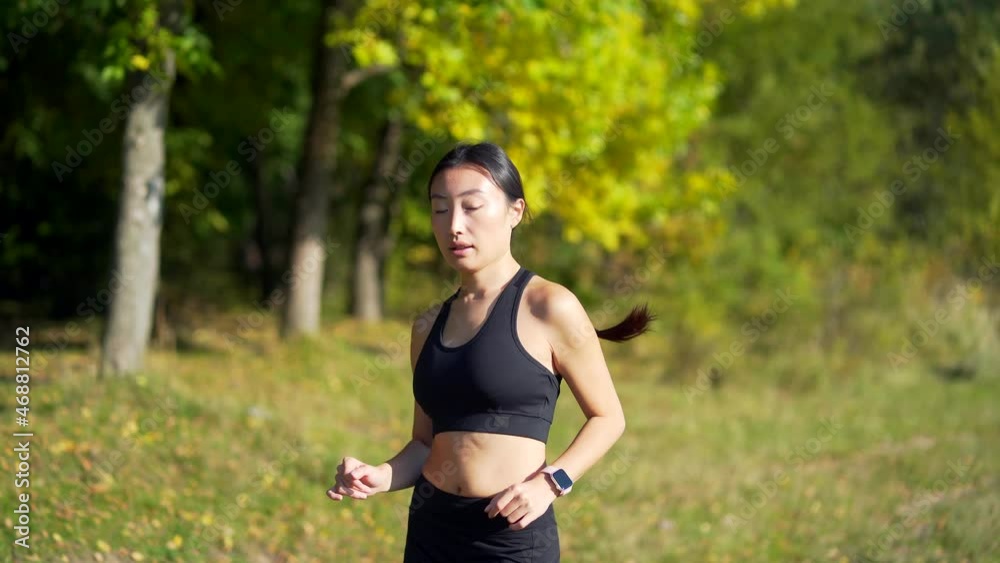Young asian happy woman runner jogging in forest or city park. Morning jog. Active healthy lifestyle. attractive fitness female. Sport workout outdoor. Athlete training run exercise in the fresh air Young asian happy woman runner jogging in forest or city park. Morning jog. Active healthy lifestyle. attractive fitness female. Sport workout outdoor. Athlete training run exercise in the fresh air