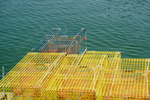 Colorful yellow stacked lobster traps make a unique abstract on Orr's Island in a working Maine Harbor photo