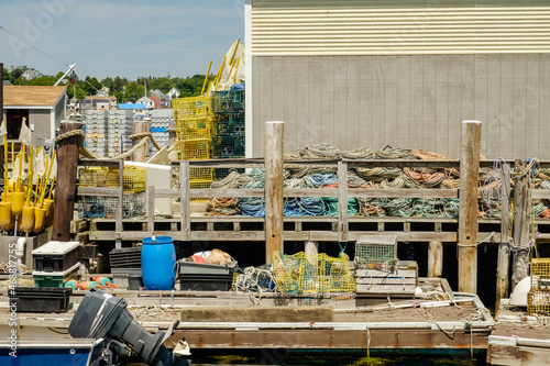 Working Lobster dock in Maine with traps and buoys photo