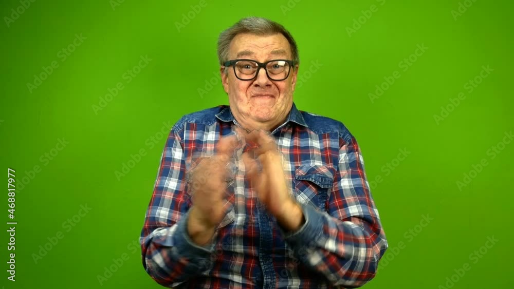Mature adult strange man in stupid glasses is emotionally claps his hands and and nods his head approvingly. Green screen. Mature adult strange man in stupid glasses is emotionally claps his hands and and nods his head approvingly. Green screen.