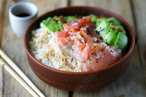 Poke bowl with rice, salmon and avocado. Sushi bowl.