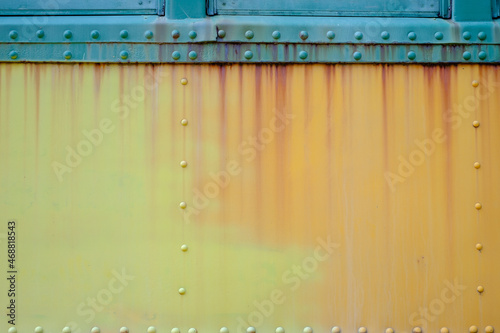 Running rust down the side of an abandoned rail passenger car