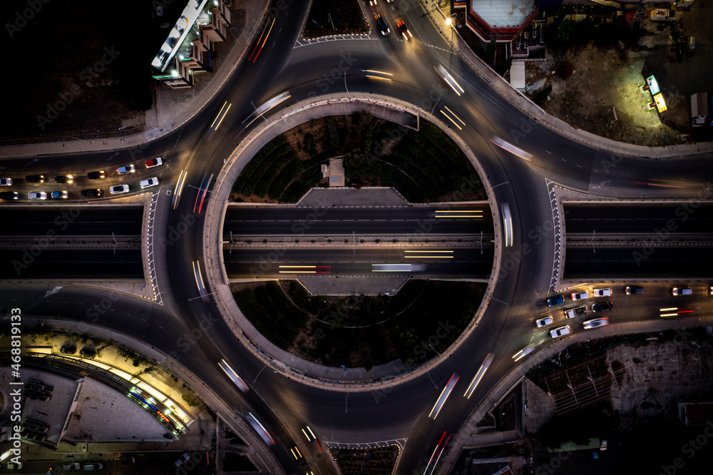 Aerial drone top view of a modern motorway junction roundabout with cars moving. Transportation infrastructure, Aerial drone top view of a modern motorway junction roundabout with cars moving. Transportation infrastructure,