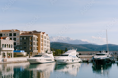Luxury yachts are moored in a row at the dock in Lustica Bay. Montenegro