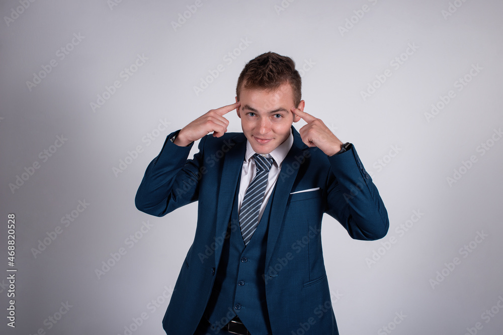 Portrait of a successful businessman on a gray background. Portrait of a successful businessman on a gray background.