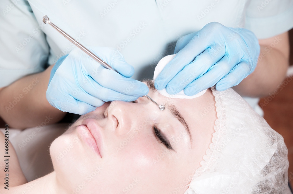 Close-up Professional face cleaning. Mechanical face cleansing procedure. Peeling of the skin of the face. Close-up Professional face cleaning. Mechanical face cleansing procedure. Peeling of the skin of the face.