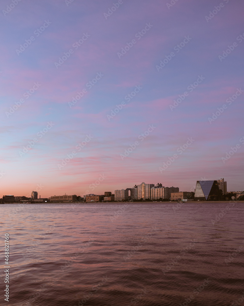 Sunset over the city on the river