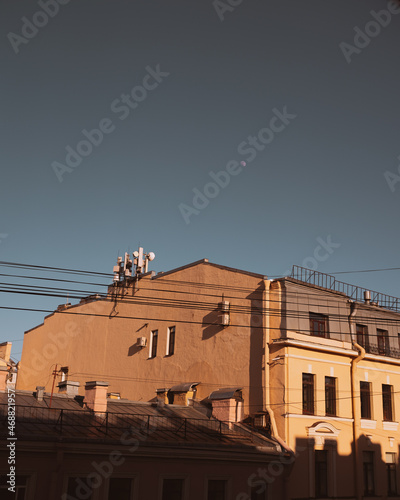 View of the moon in the blue sky in the city