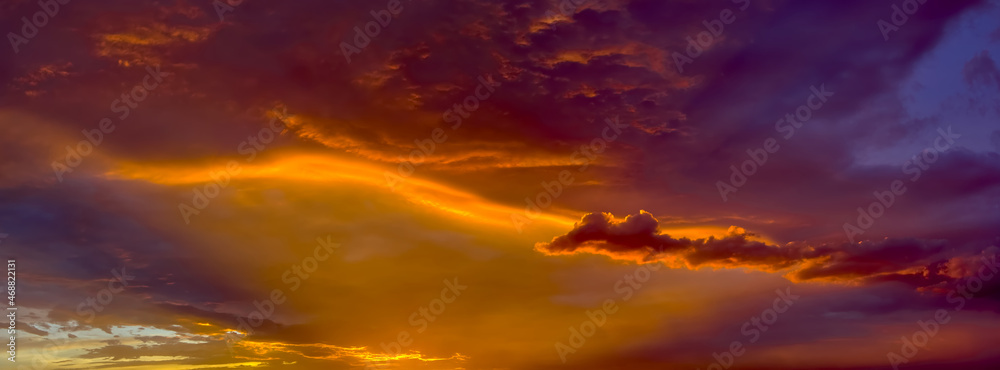 The rays of the setting sun creating red and yellow hues on the underside of a late day storm during the Arizona Monsoon season of 2014.