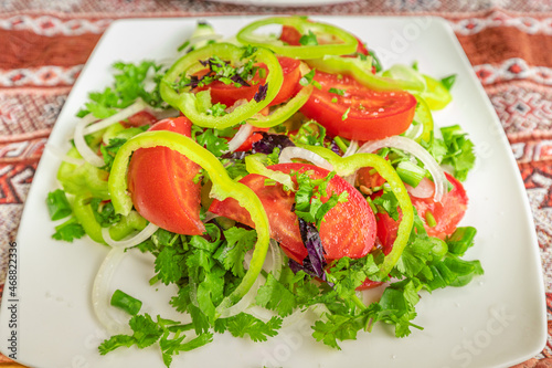 A simple summer salad with tomatoes and greens is a healthy snack