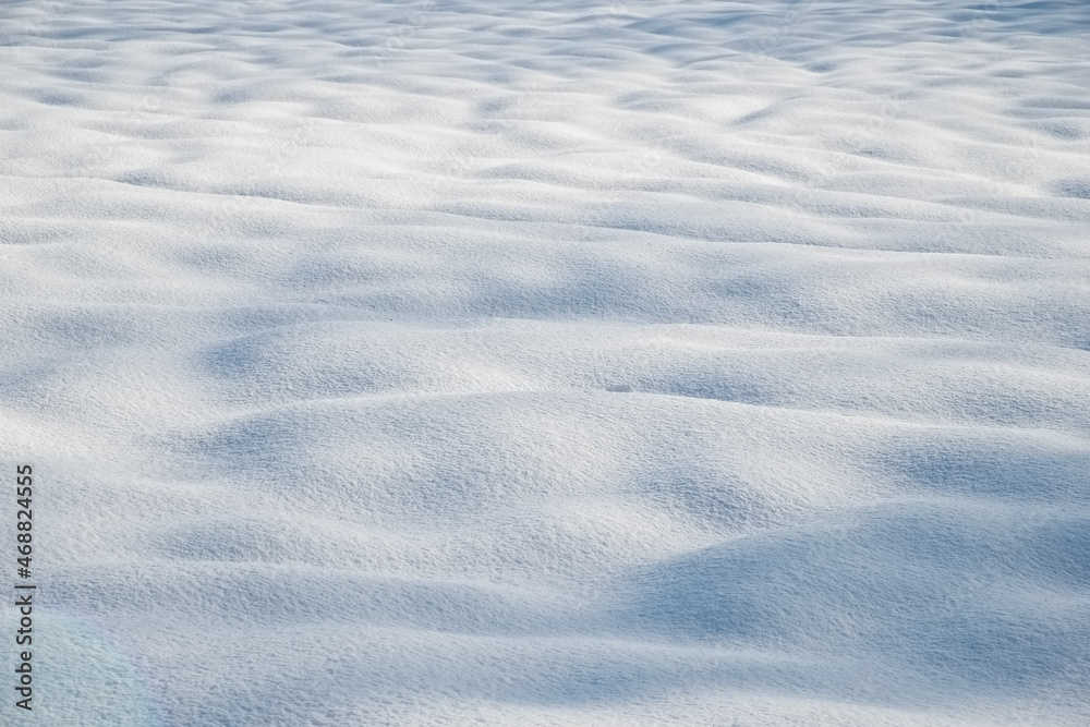 Snow mounds and mogels in fresh powder snow with light shadows Snow mounds and mogels in fresh powder snow with light shadows