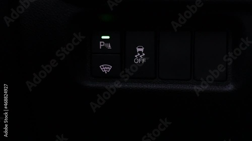 Button to turn on and off parking radars. Activating parking sensors from the front in a modern car.