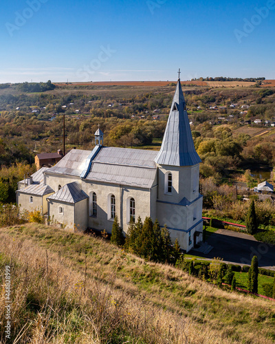 Catholic church in the valley of the village Zinkiv on an autumn day. Ukraine.
