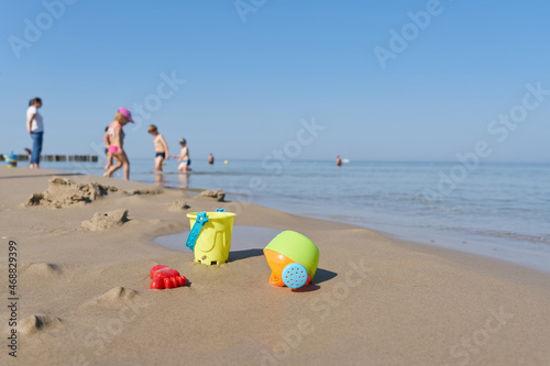 Children toys and children in summer on the beach of the Baltic Sea coast near Kolobrzeg in Poland photo