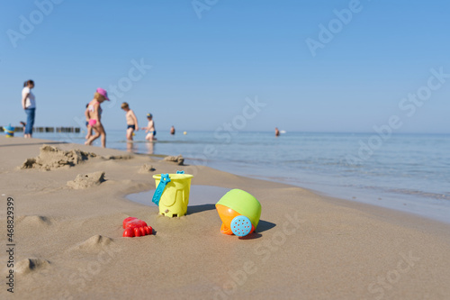 Fototapeta Naklejka Na Ścianę i Meble -  Children toys and children in summer on the beach of the Baltic Sea coast near Kolobrzeg in Poland