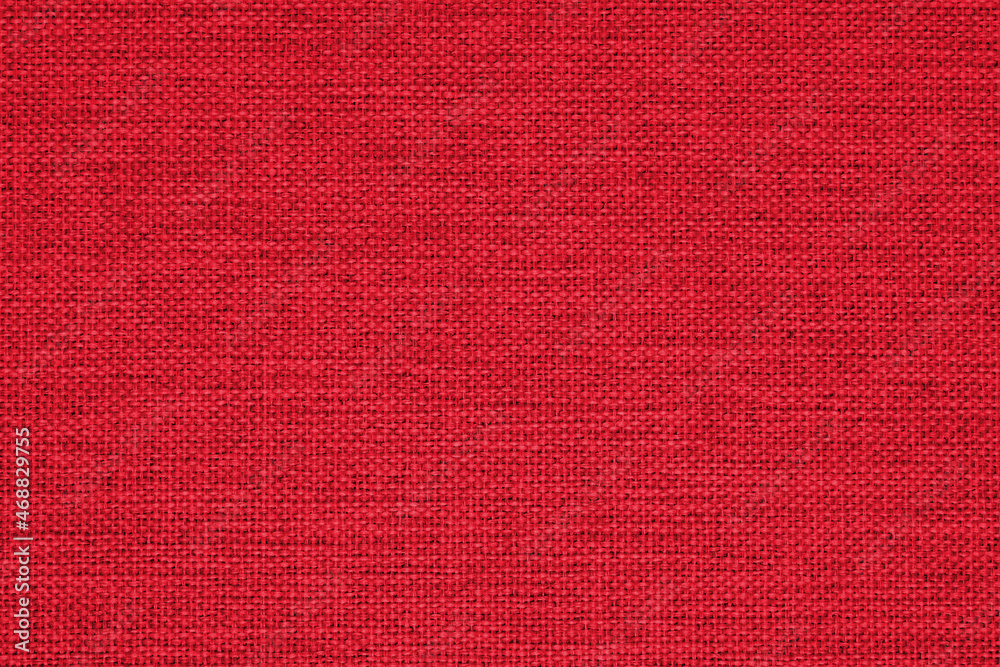 Close-up of a red woven surface. The texture is similar to linen. Fabric background for Christmas or New Year. Vivid textured woven backdrop Close-up of a red woven surface. The texture is similar to linen. Fabric background for Christmas or New Year. Vivid textured woven backdrop