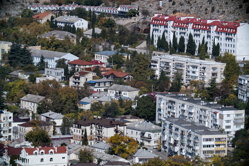 Coastal zone in Balaklava, Crimea. Snow-white hotels among autumn trees. Tourist area