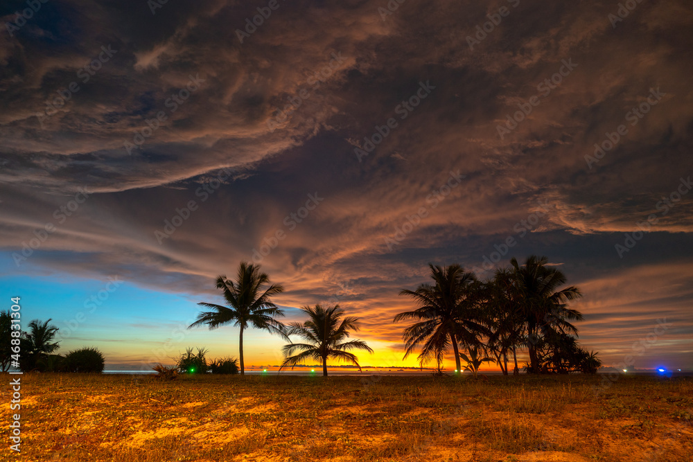 scenery sunset above coconut trees during colorful .cloud in sunset on Karon beach Phuket Thailand. .Scene of Colorful red light in the sky background. scenery sunset above coconut trees during colorful .cloud in sunset on Karon beach Phuket Thailand. .Scene of Colorful red light in the sky background.