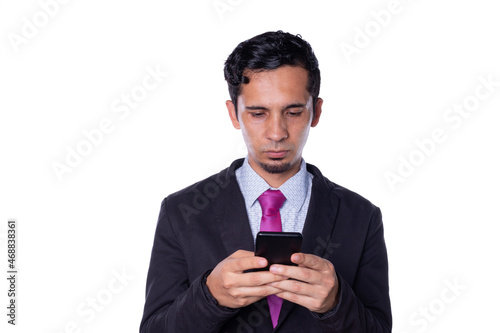 Businessman using a smart phone. Young adult wearing a smart suit checks your cell phone. Isolated on all white background.