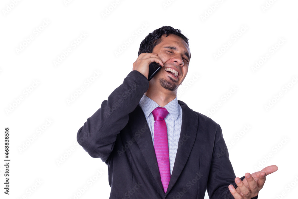 Businessman laughs while talking on the phone. Young adult using a smart phone. Concept of expressions of an entrepreneur. Person using technology isolated on all white background. Businessman laughs while talking on the phone. Young adult using a smart phone. Concept of expressions of an entrepreneur. Person using technology isolated on all white background.