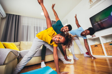 Healthy morning stretching - family doing gymnastic exercise at home