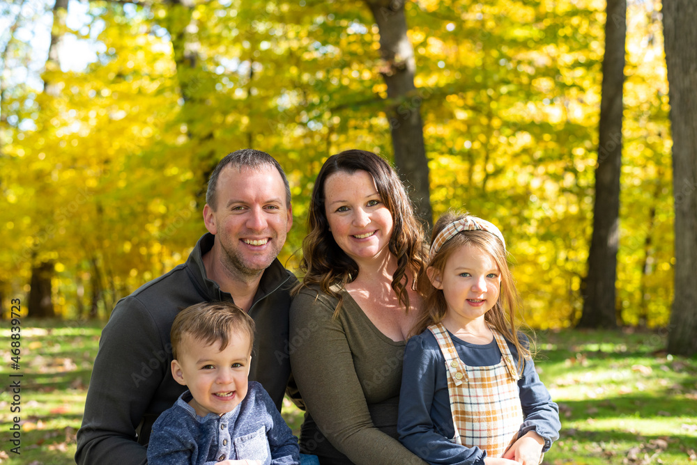 Fall portrait of happy young couple with two children Fall portrait of happy young couple with two children