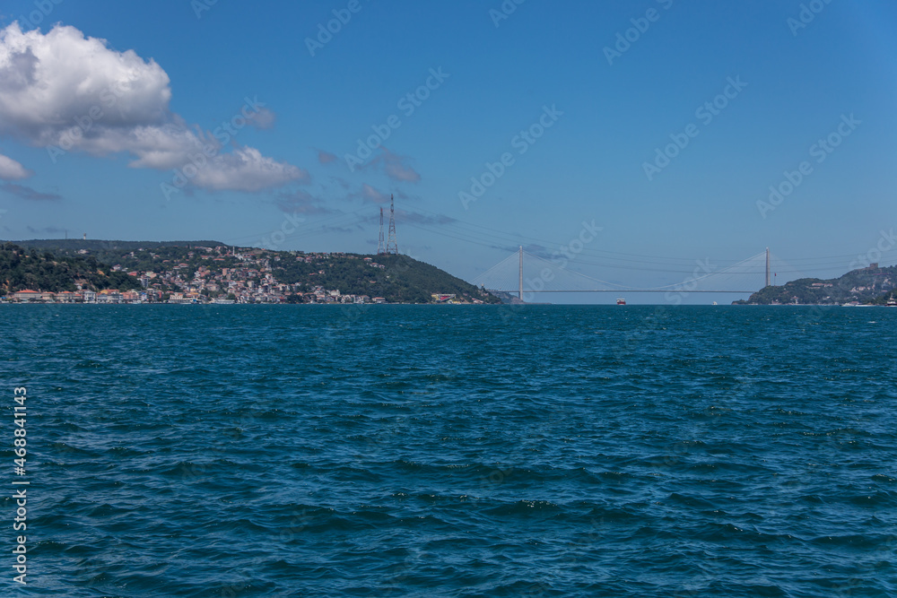 The third bridge view from a distance  over the blue Bosphorus Istanbul, under the beautiful sky with white clouds.