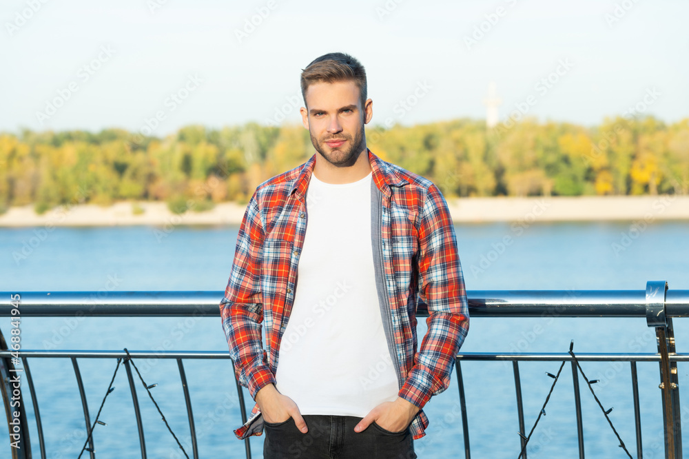 young trendy male fashion model in casual shirt outside, fashion