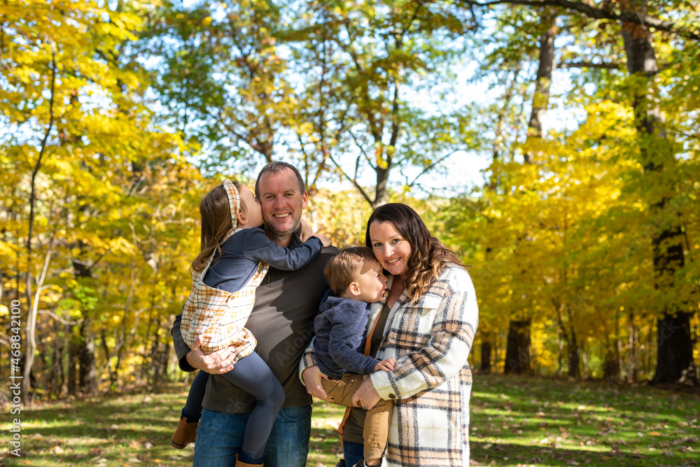 Happy young couple with two little kids Happy young couple with two little kids