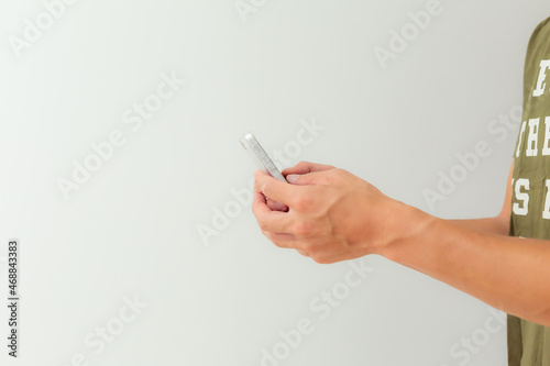 a man texting with mobile phone in front of white background