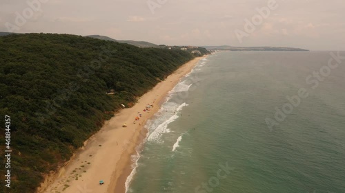 Wallpaper Mural aerial drone top view over ocean Black sea sand beach rocky mountains cliffs dense forest bright sunny day. flying low above waves curling on shore 4k Bulgaria Europe. summer warm weather temperature Torontodigital.ca