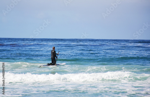 Man surfing in the ocean near California beach
