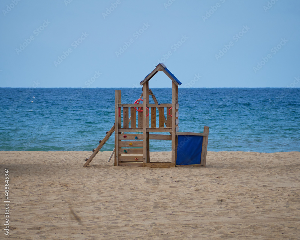 Beautiful Wooden Colorful children playground on a beach by the sea. Beautiful Wooden Colorful children playground on a beach by the sea.