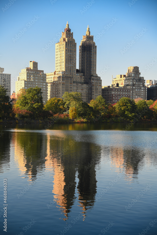 Central Park Reservoir or Jacqueline Kennedy Onassis Reservoir in New York city during the autumn season. Beautiful sunny day with warm weather and blue sky.