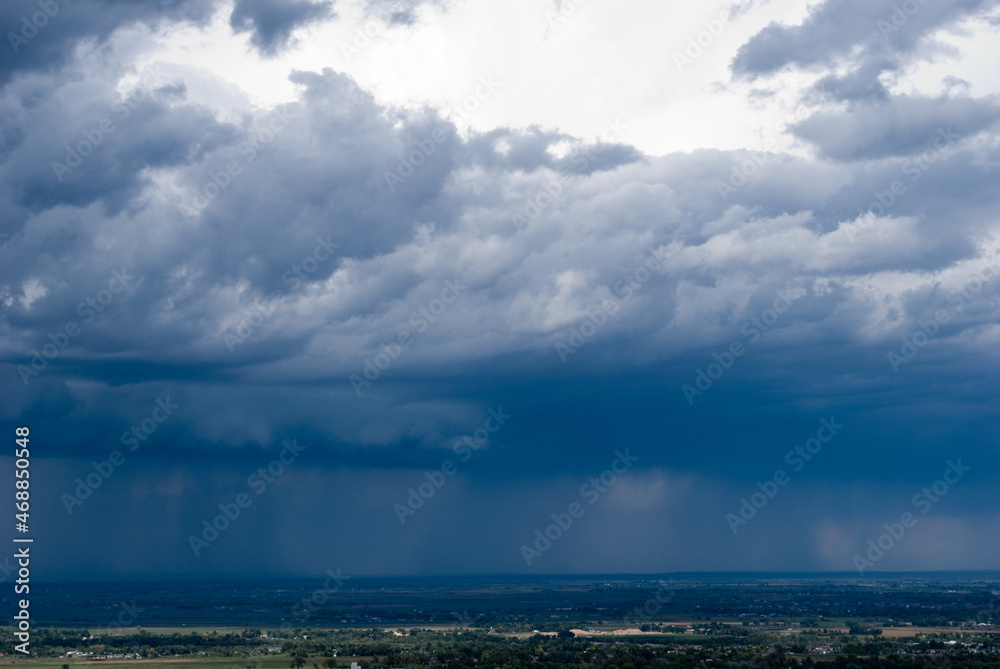 View of Fort Collins from the Horseshoe reservoir with rain in the background