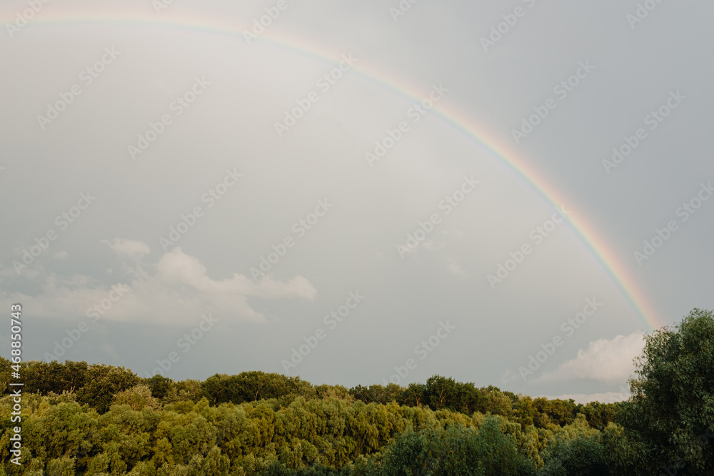 Rainbow after rain on cloudy sky Rainbow after rain on cloudy sky