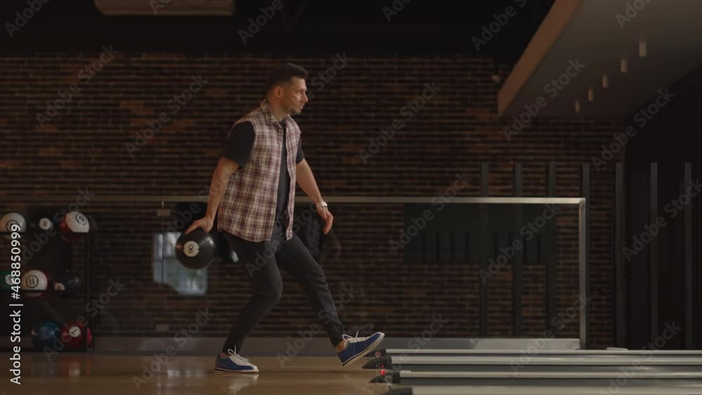 One Caucasian man throws a bowling ball and knocks out a shoot dances jumps and sings rejoicing in victory. One Caucasian man throws a bowling ball and knocks out a shoot dances jumps and sings rejoicing in victory.