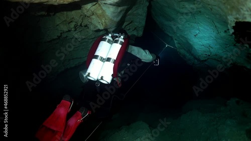 Budapest - 17 August 2017: Technical diver in red flippers in the underwater cave of Budapest photo