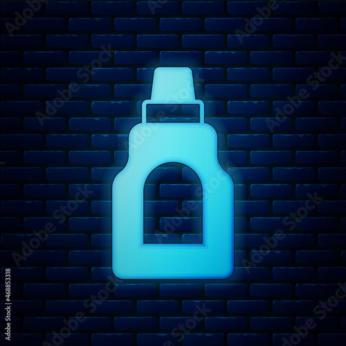 Glowing neon Plastic bottle for laundry detergent, bleach, dishwashing liquid or another cleaning agent icon isolated on brick wall background. Vector