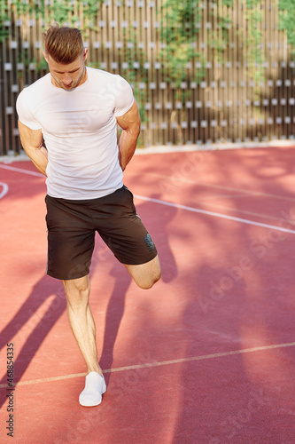 man in white t-shirt on the sports ground workout motivation